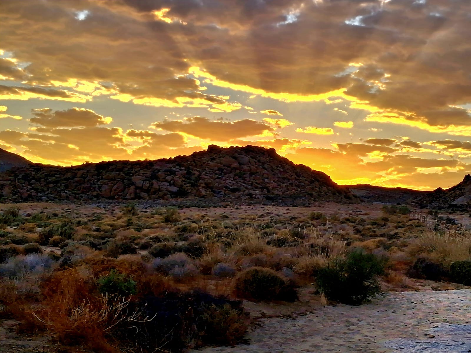 Sunset over rocky hills at Paardekraal Kliphuis